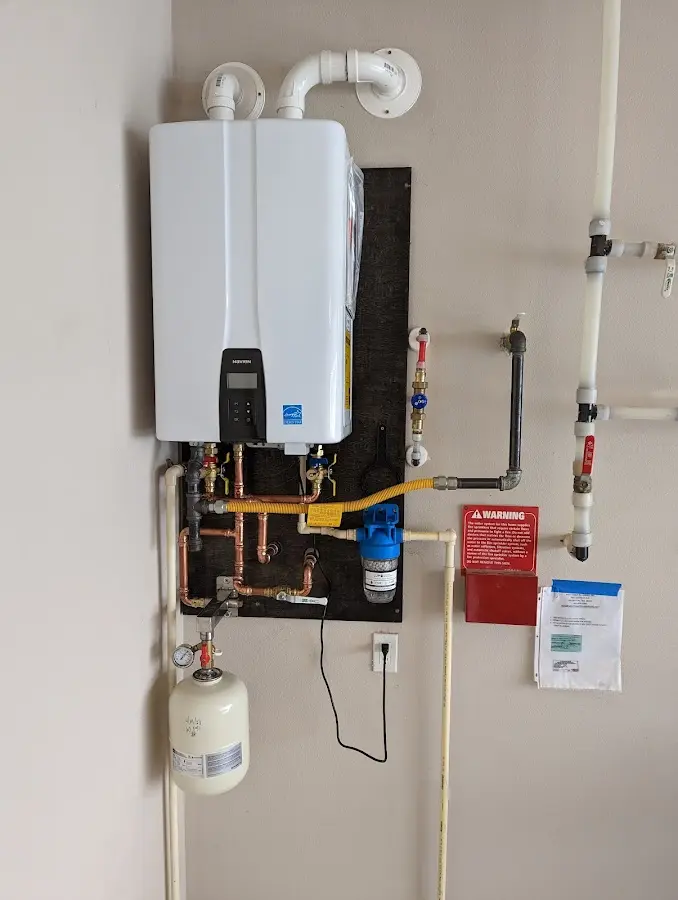 Professional plumber installing copper piping in a Bradley home